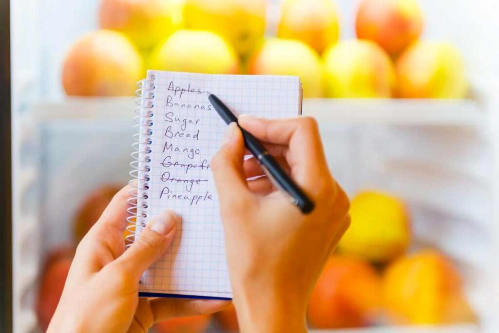 handwritten grocery list with vegetables written on it