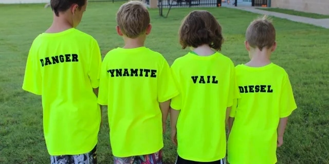 4 children wearing bright neon green t-shirts